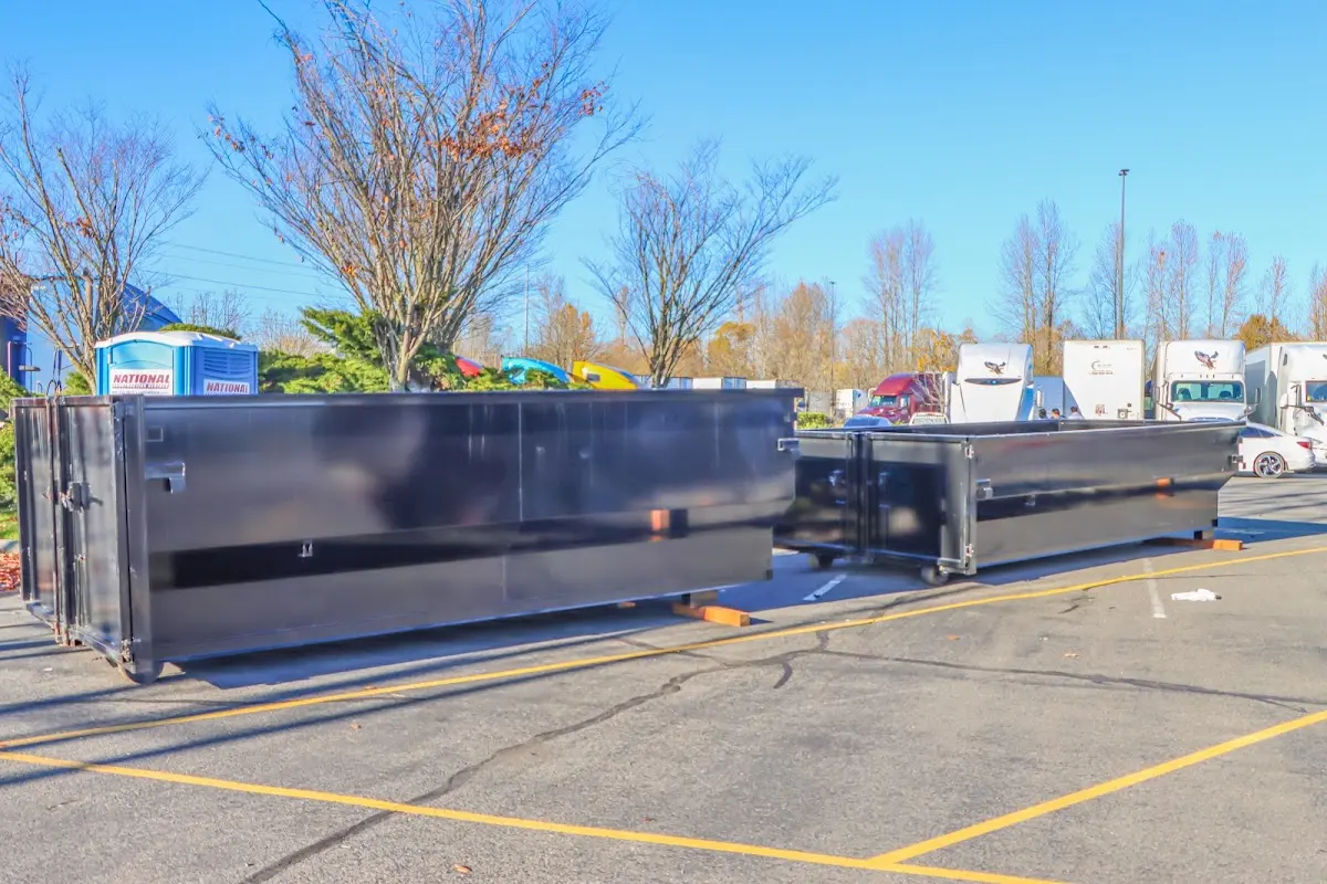 Professional dumpster rental service with roll-off container on residential driveway in Overlea